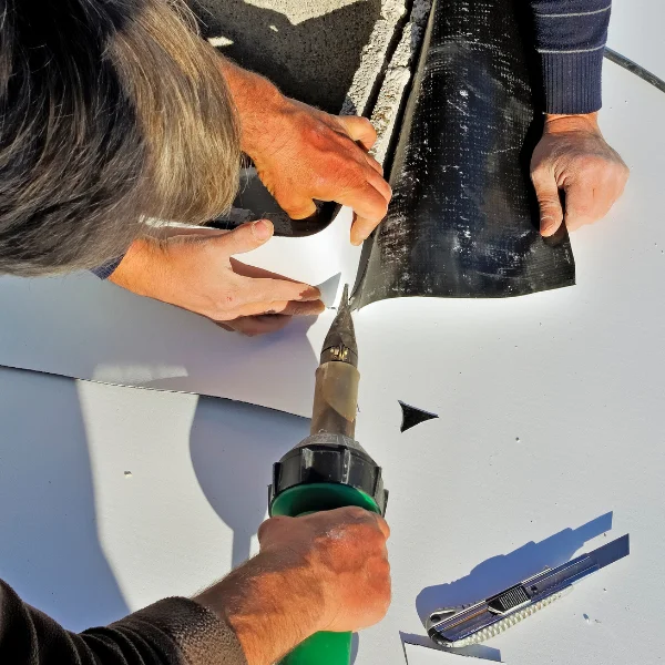 An image showing TPO roofing installation on a commercial building.